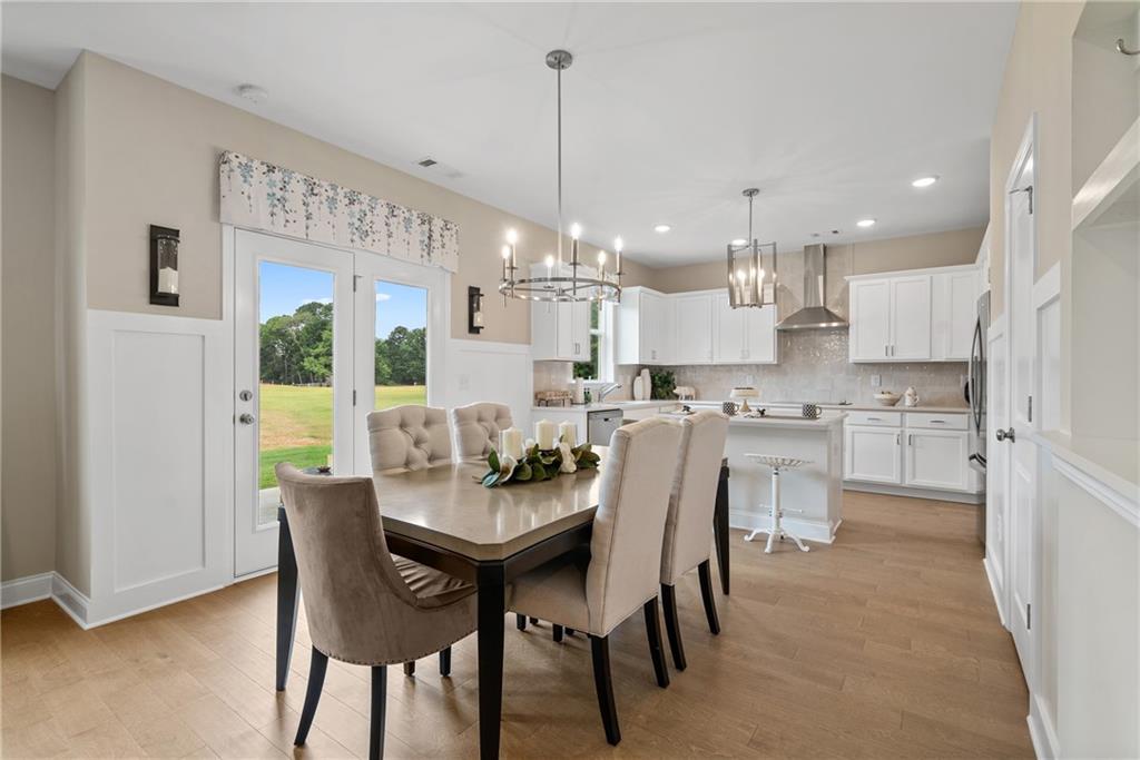 112 Bridgeview (lot 4) Way Canton, GA 30114 - Photo 15 of 45 a view of a dining room and livingroom with furniture wooden floor a chandelier