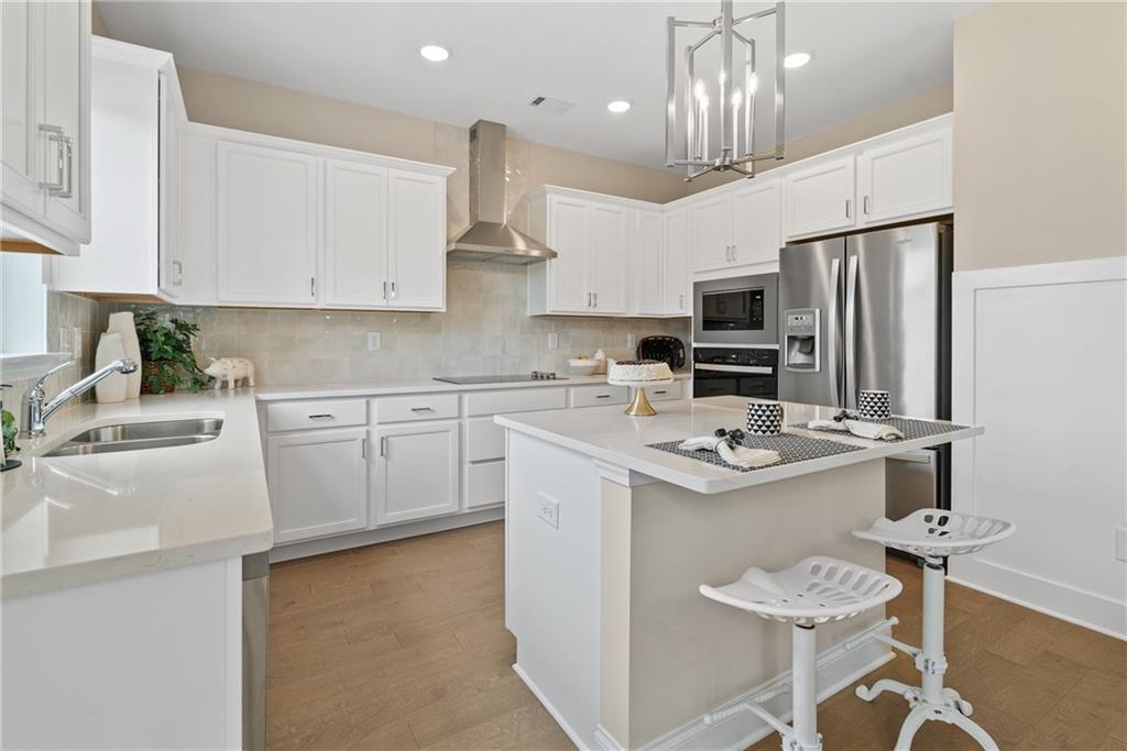 112 Bridgeview (lot 4) Way Canton, GA 30114 - Photo 18 of 45 a kitchen with stainless steel appliances a sink a stove a refrigerator cabinets and chairs