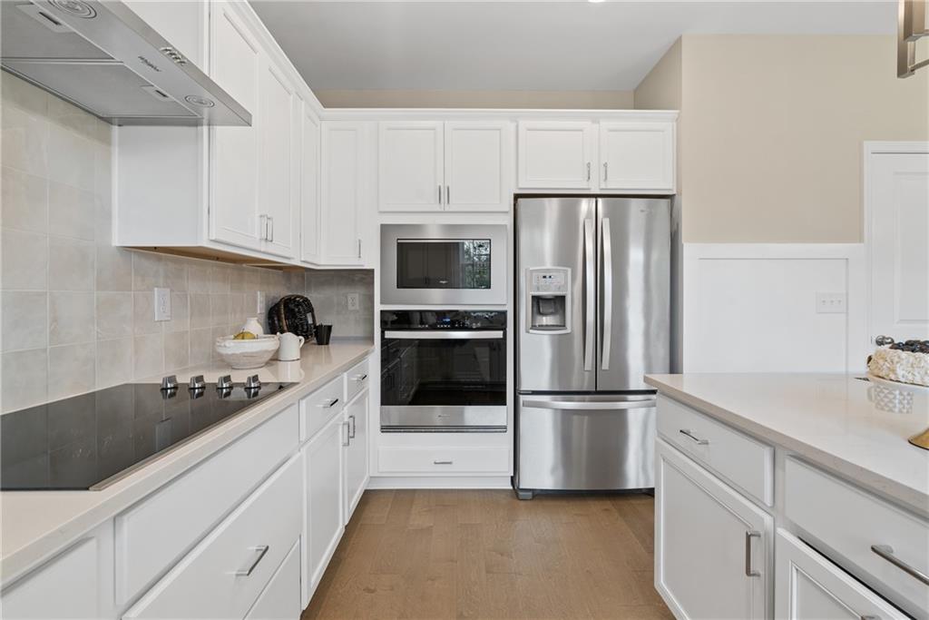 112 Bridgeview (lot 4) Way Canton, GA 30114 - Photo 19 of 45 a kitchen with granite countertop a refrigerator and cabinets