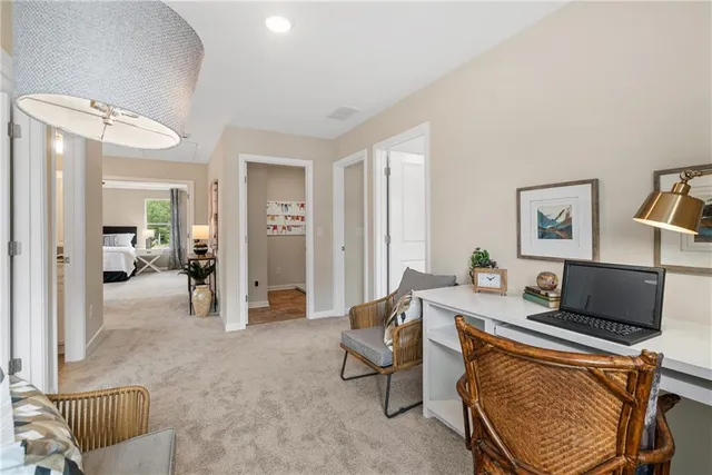 a spacious bedroom with a bed and ceiling fan