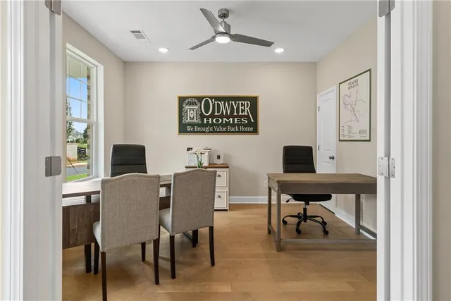 a view of a workspace with furniture and window