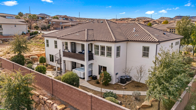 2311 South 1340 West St. George, UT 84770 - Photo 1 of 56 Back of property with a fenced backyard, stucco siding, a balcony, a tile roof, and a residential view