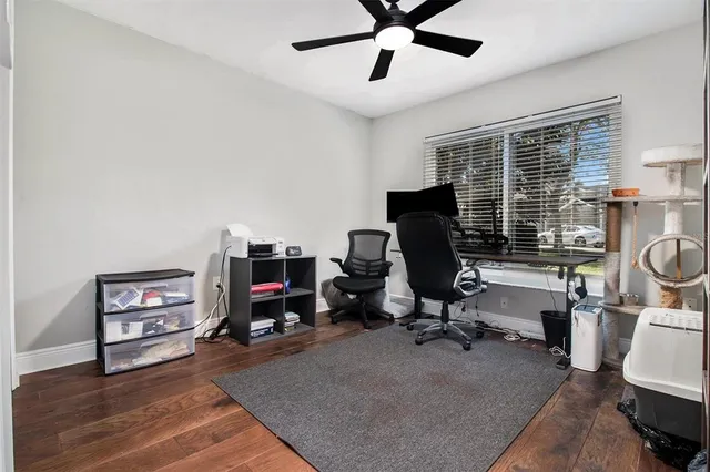 a view of a workspace with furniture and a window