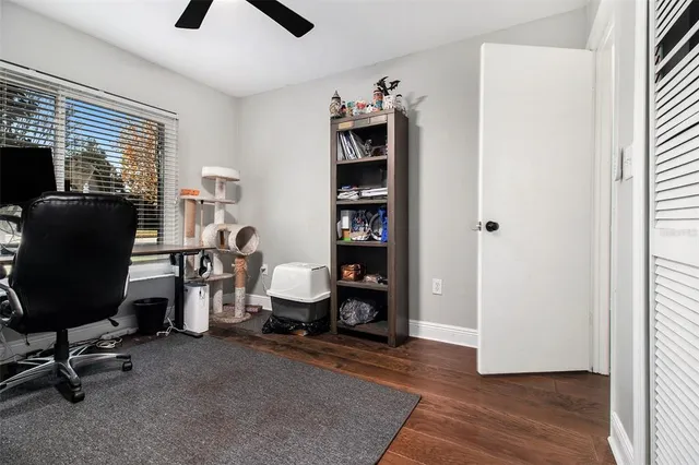 a view of a workspace with furniture and a window