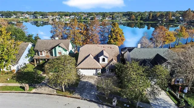 an aerial view of a house with a lake view