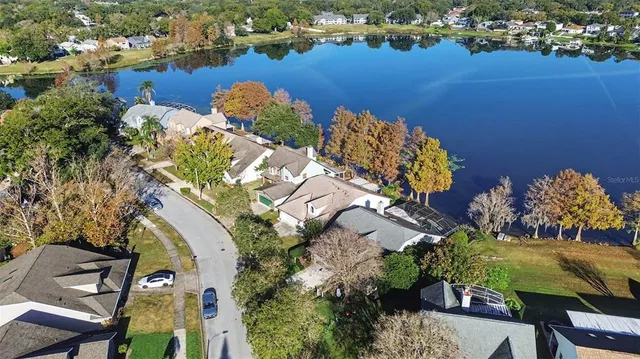 an aerial view of a house with a lake view