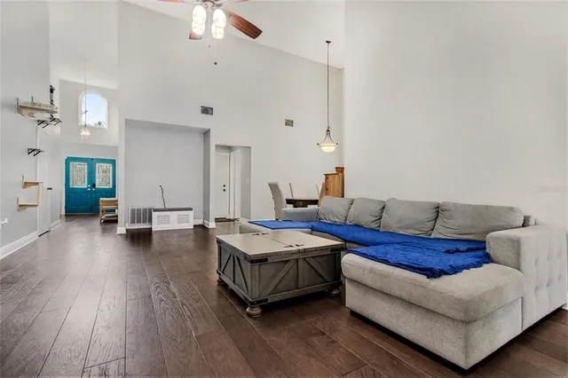 a living room with furniture and wooden floor