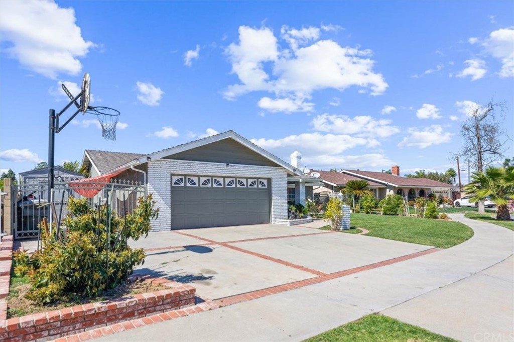 1013 London Circle Placentia, CA 92870 - Photo 2 of 45 a front view of a house with a yard and a garage