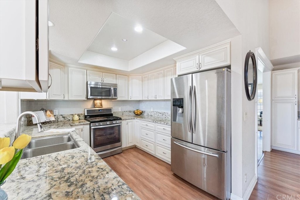 1013 London Circle Placentia, CA 92870 - Photo 23 of 45 a kitchen with stainless steel appliances a refrigerator sink and microwave