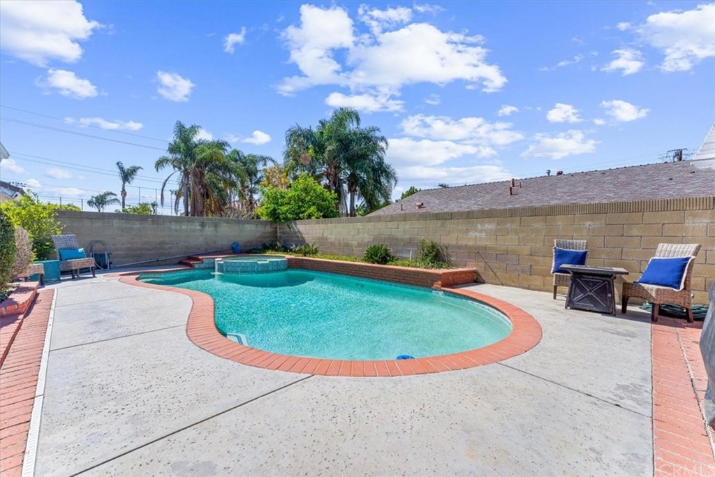 1013 London Circle Placentia, CA 92870 - Photo 32 of 45 a view of a swimming pool with lawn chairs and a fire pit