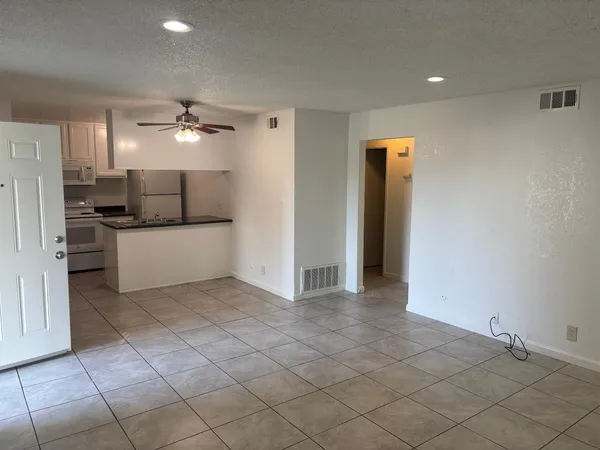 a large kitchen with a sink and a stove top oven