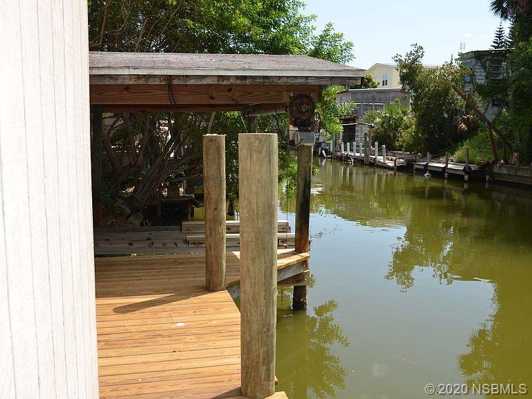 118 Charles Street Edgewater, FL 32141 - Photo 8 of 8 a backyard of a house with a lake view
