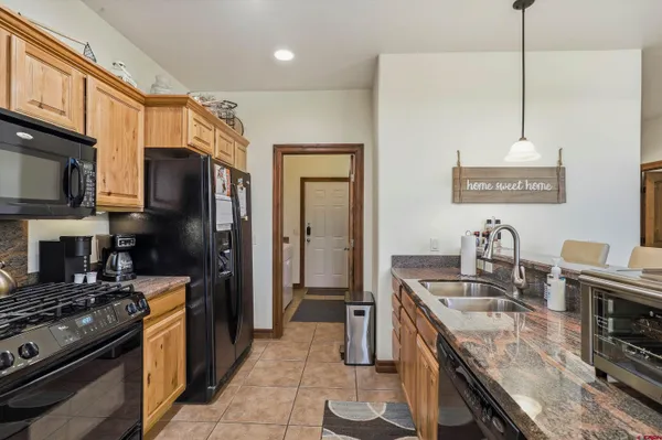 a kitchen with stainless steel appliances granite countertop a stove refrigerator and a microwave