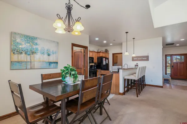 a large kitchen with a table and chairs