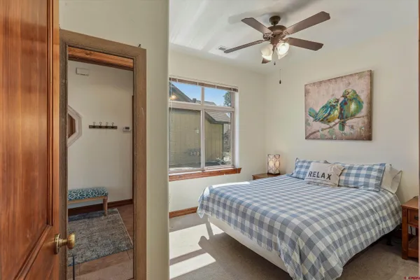 a bedroom with a bed and a painting on the wall