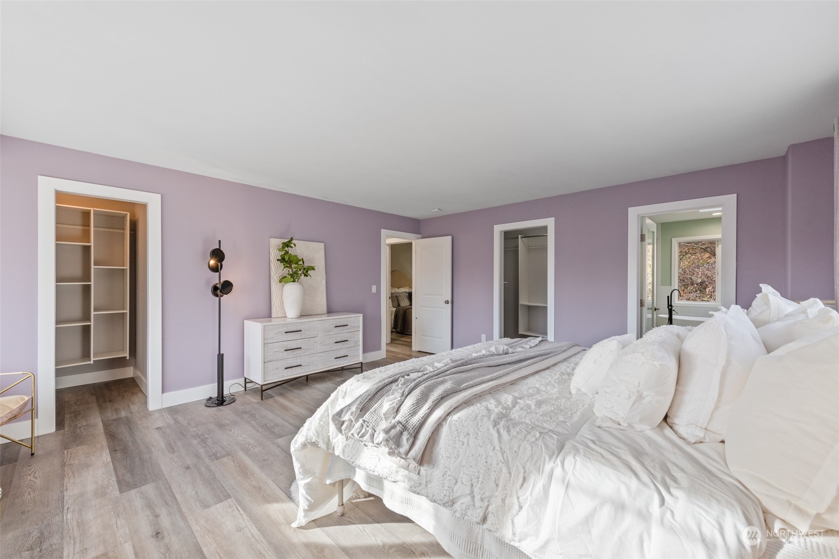 1701 226th Place Southwest Bothell, WA 98021 - Photo 16 of 30 a spacious bedroom with a bed and wooden floor