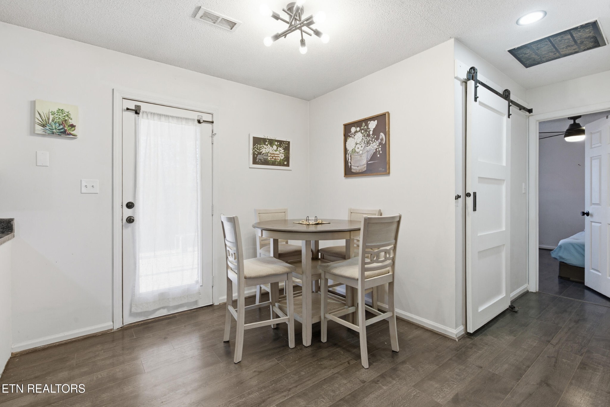 7712 Ralph Youmans Road Corryton, TN 37721 - Photo 11 of 33 a view of a dining room with furniture and wooden floor