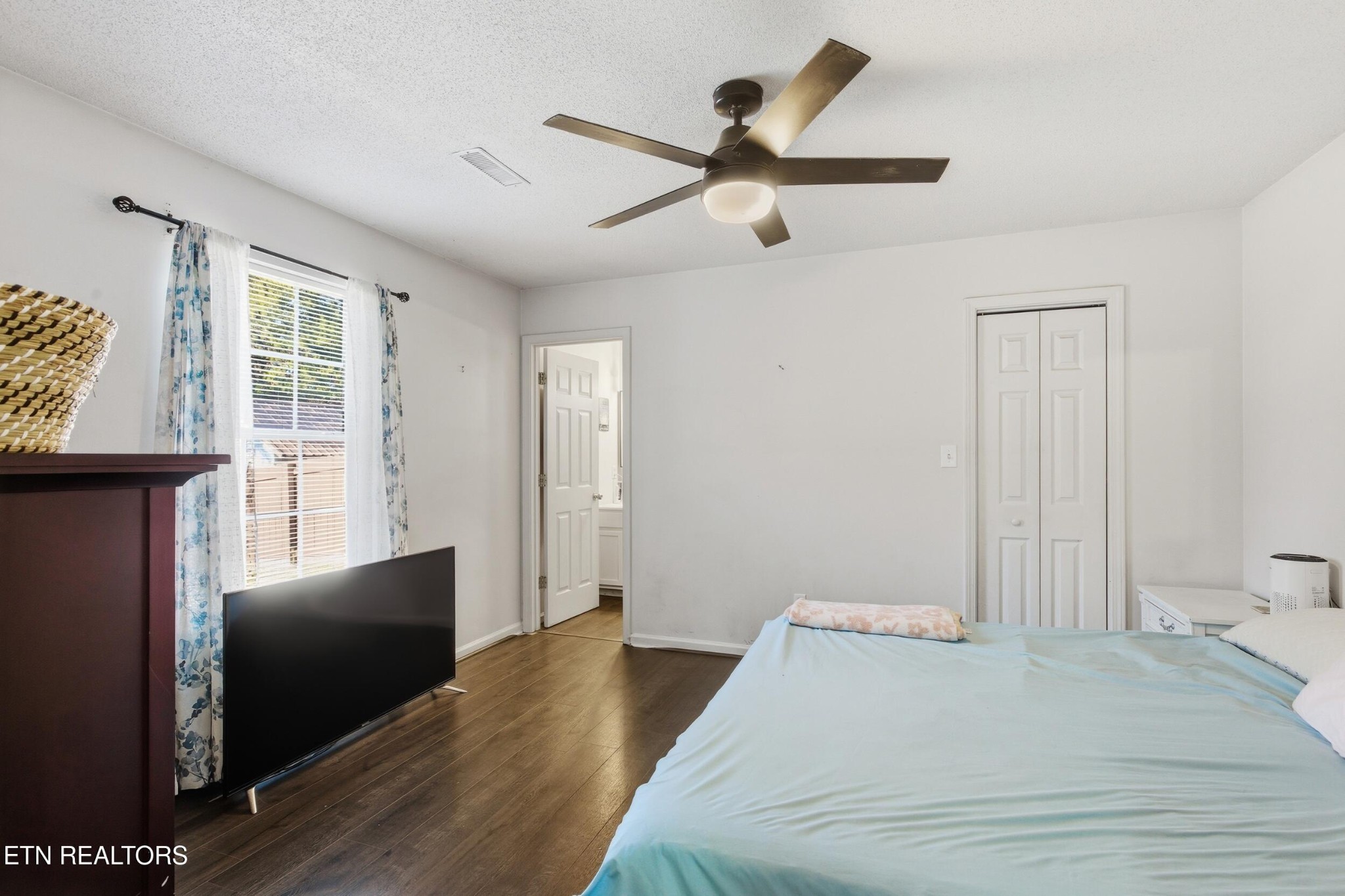 7712 Ralph Youmans Road Corryton, TN 37721 - Photo 14 of 33 a bedroom with a bed and a chandelier