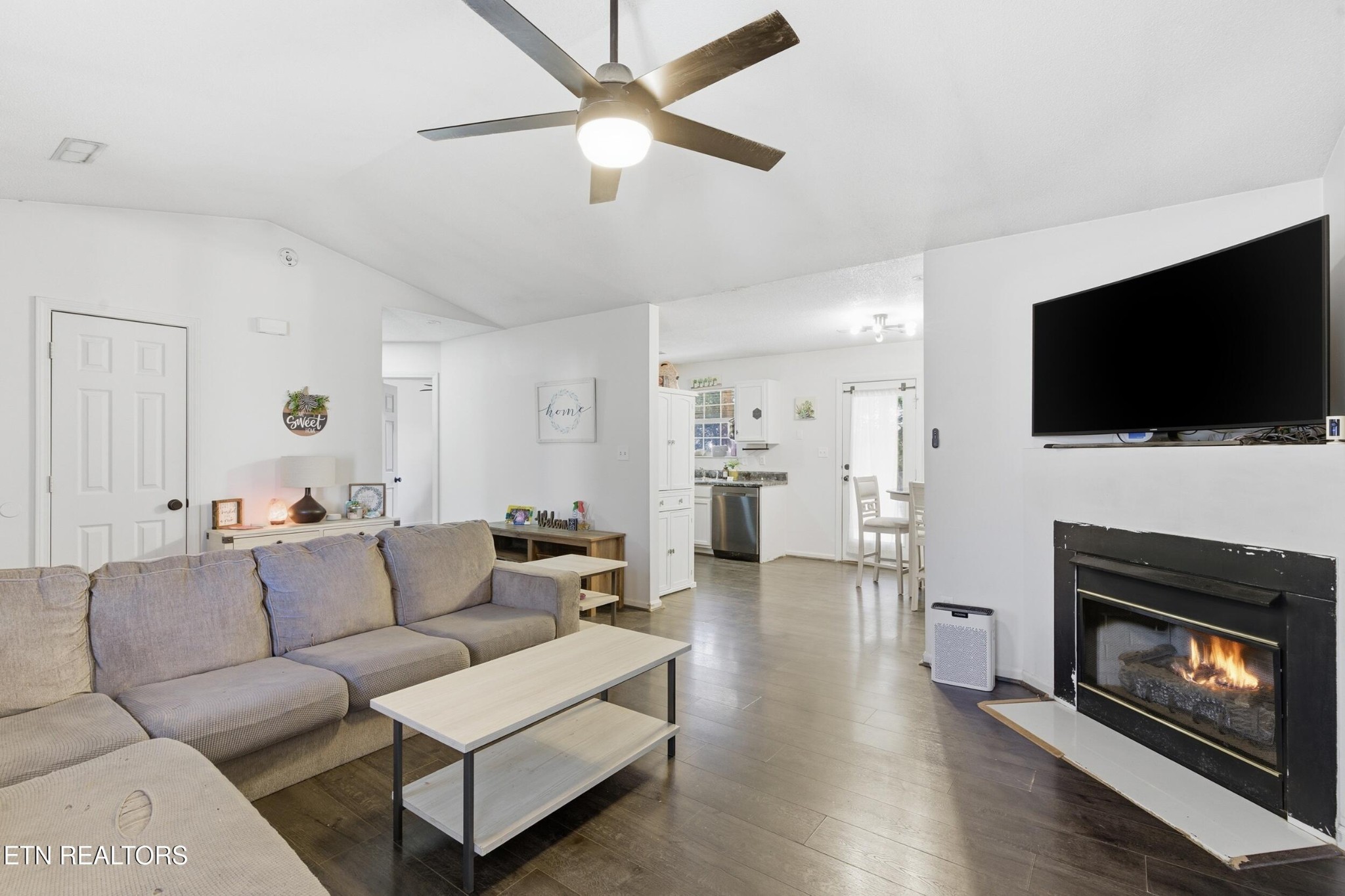 7712 Ralph Youmans Road Corryton, TN 37721 - Photo 7 of 33 a living room with furniture a flat screen tv and a fireplace