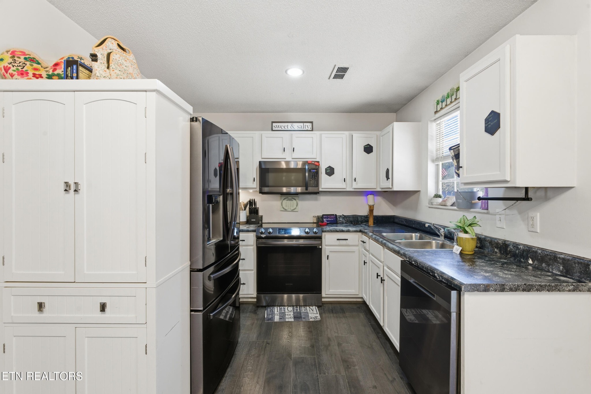 7712 Ralph Youmans Road Corryton, TN 37721 - Photo 9 of 33 a kitchen with granite countertop a refrigerator stove and sink