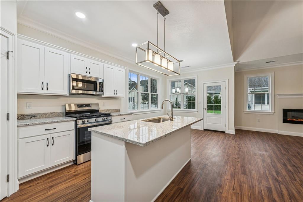 406 Kastner Street Ligonier, PA 15658 - Photo 11 of 35 a kitchen with stainless steel appliances granite countertop hardwood floor sink stove and wooden cabinets