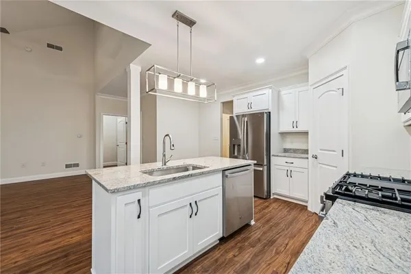 a view of kitchen with cabinets and wooden floor