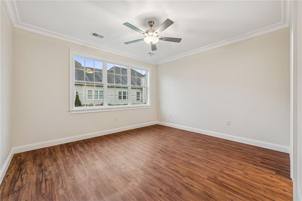 406 Kastner Street Ligonier, PA 15658 - Photo 22 of 35 an empty room with wooden floor chandelier fan and windows
