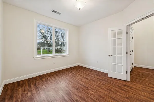 a bathroom with a toilet sink vanity and mirror