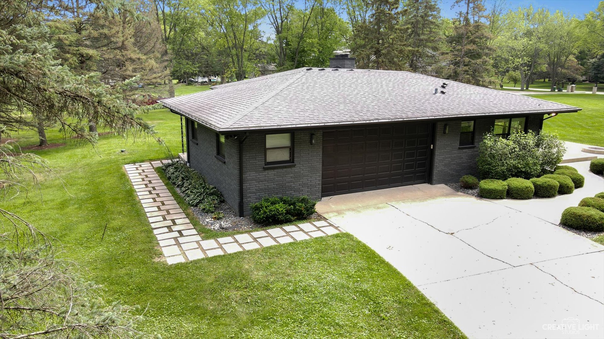 5N133 Kaelin Road Wayne, IL 60184 - Photo 3 of 35 a front view of house with yard and trees in the background