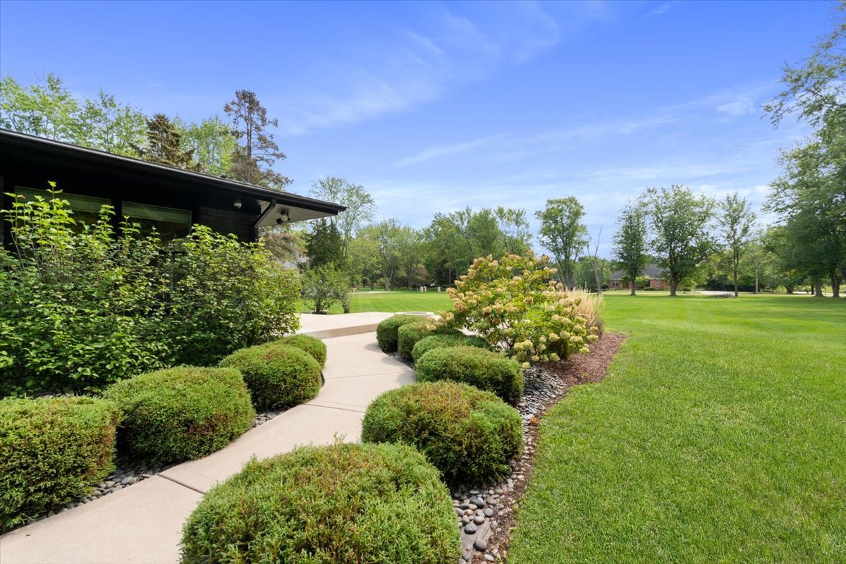 5N133 Kaelin Road Wayne, IL 60184 - Photo 4 of 35 a view of a garden with plants and a bench
