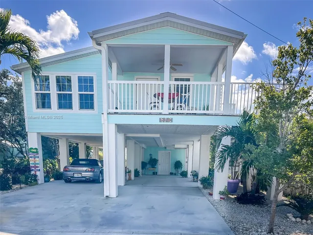 a view of a house with a porch and furniture