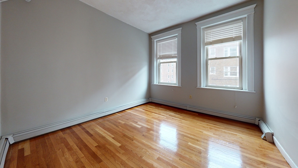 1625 Commonwealth Avenue, Unit 9 Boston, MA 02135 - Photo 4 of 8 a view of an empty room and window