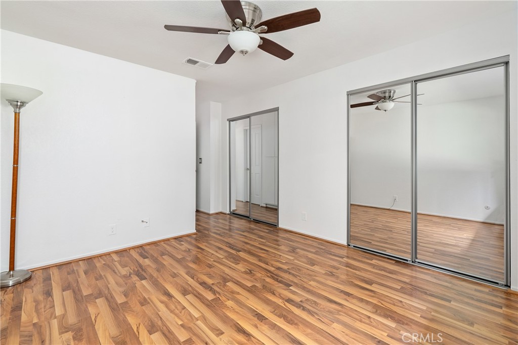 18 Flag Way Paso Robles, CA 93446 - Photo 12 of 22 a view of an empty room with wooden floor and a ceiling fan