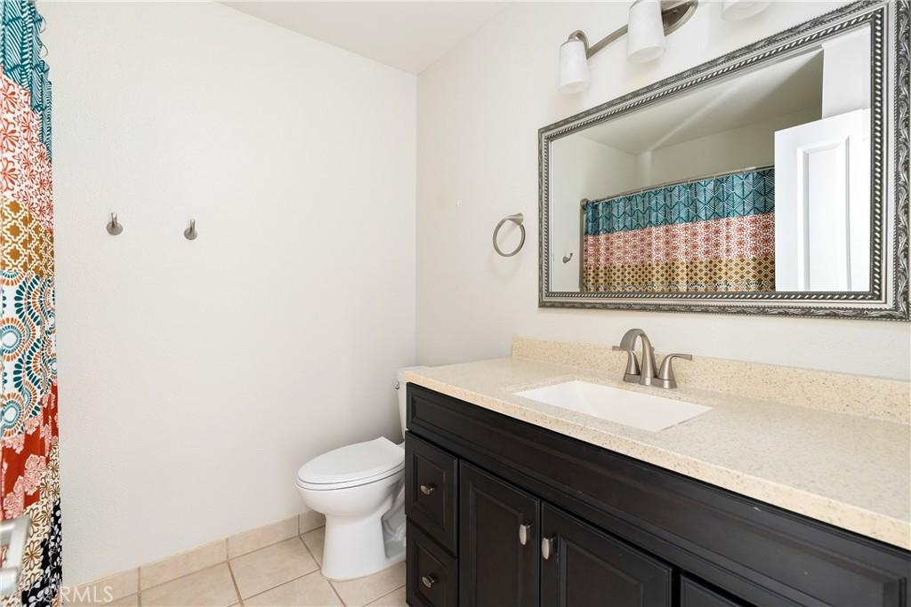 18 Flag Way Paso Robles, CA 93446 - Photo 14 of 22 a bathroom with a toilet a sink and mirror