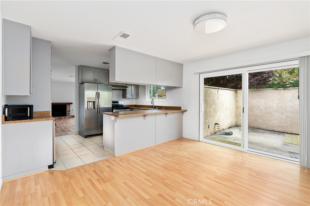 18 Flag Way Paso Robles, CA 93446 - Photo 9 of 22 a kitchen with kitchen island a counter top space a sink stainless steel appliances and cabinets