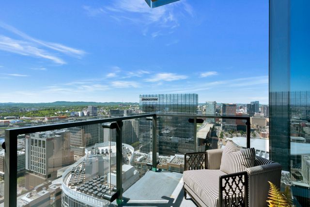 a bedroom with a bed next to a large window with the outer view