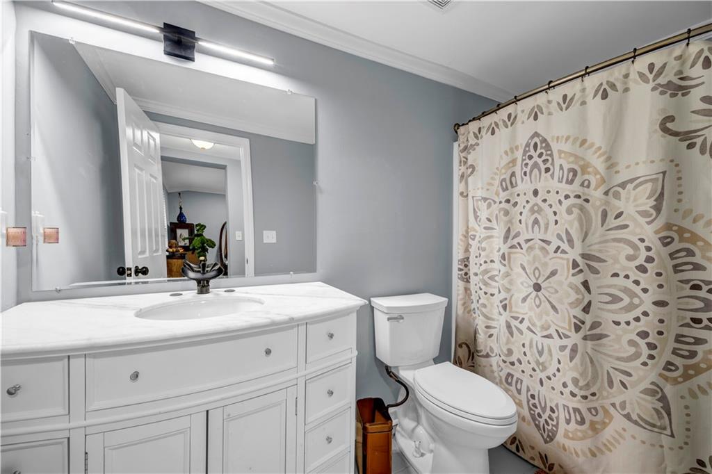 545 Grant Street Southwest Atlanta, GA 30315 - Photo 16 of 18 a bathroom with a sink and a mirror