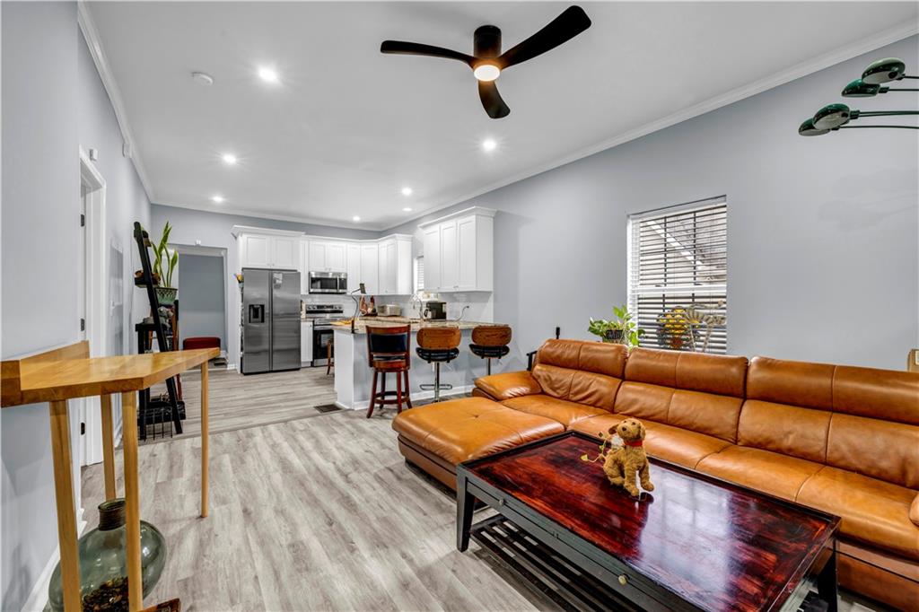 545 Grant Street Southwest Atlanta, GA 30315 - Photo 5 of 18 a living room with furniture kitchen view and a wooden floor