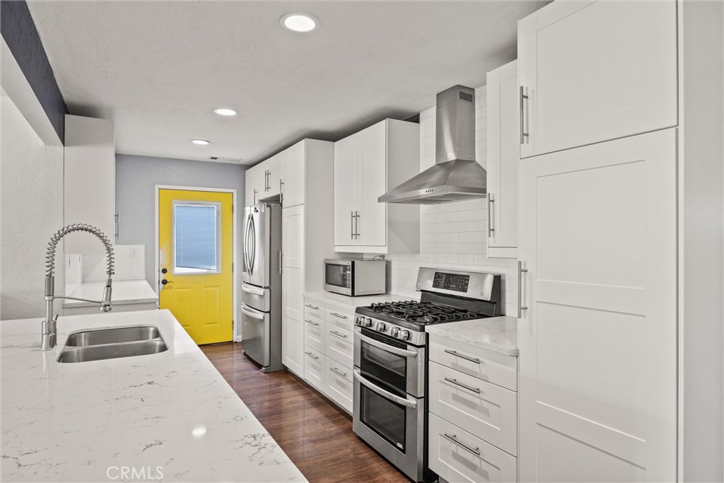 417 Jefferson Street Willows, CA 95988 - Photo 11 of 32 a kitchen with a stove and a white refrigerator