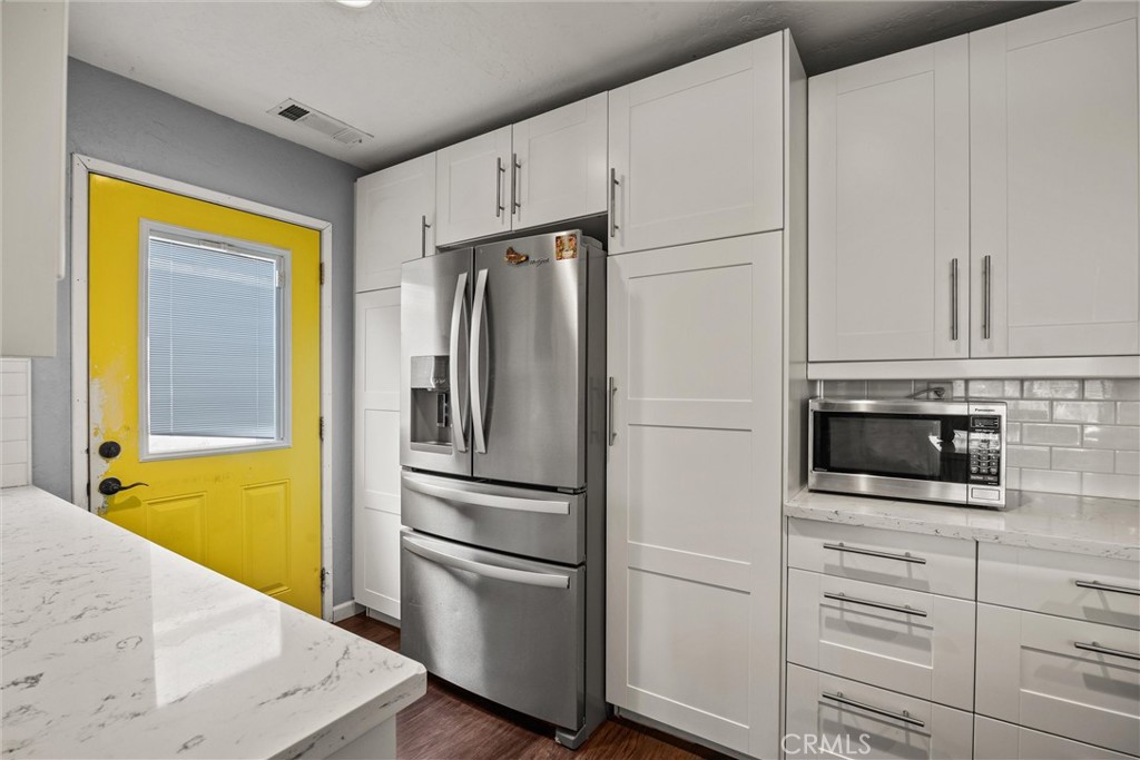 417 Jefferson Street Willows, CA 95988 - Photo 13 of 32 a kitchen with white cabinets and stainless steel appliances