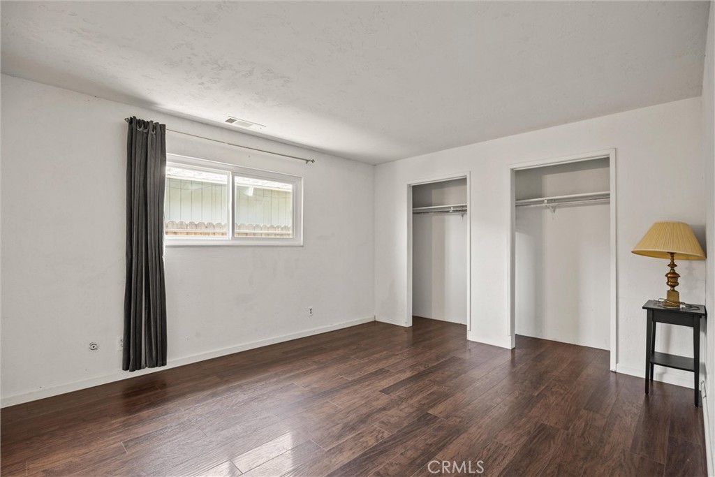 417 Jefferson Street Willows, CA 95988 - Photo 19 of 32 a view of an empty room with wooden floor and a lamp