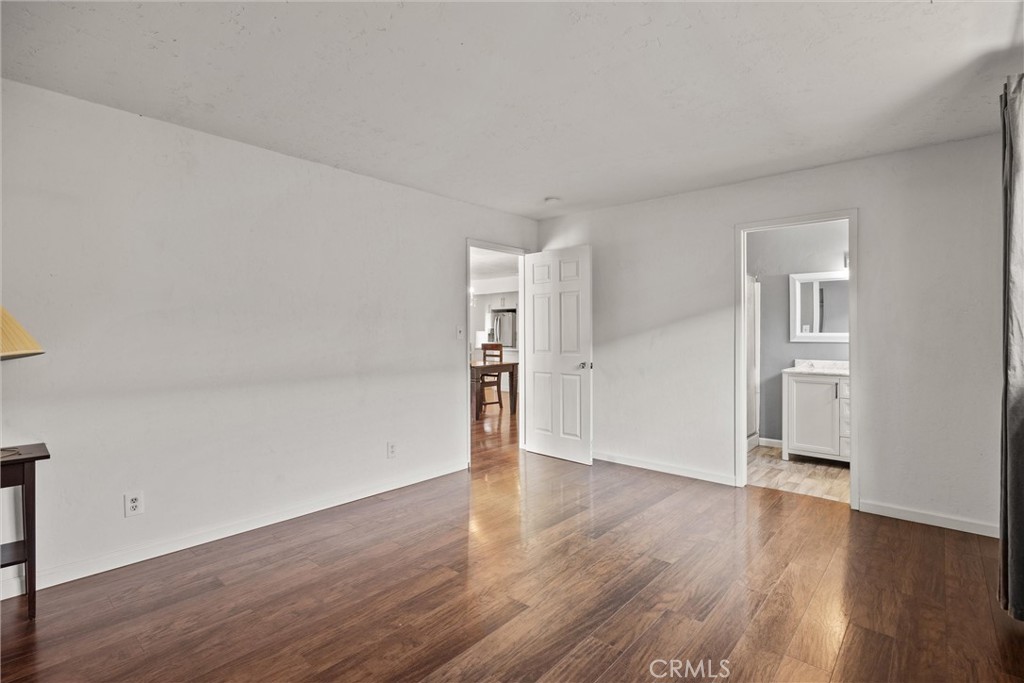 417 Jefferson Street Willows, CA 95988 - Photo 20 of 32 an empty room with wooden floor & windows and bathroom