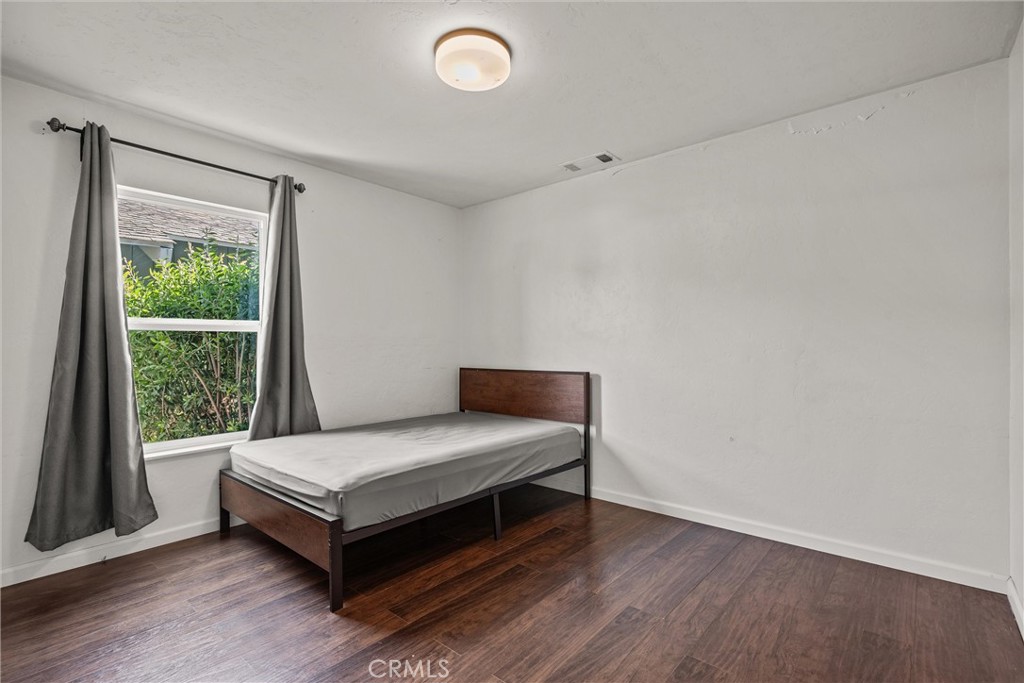 417 Jefferson Street Willows, CA 95988 - Photo 22 of 32 a bedroom with a bed and a window