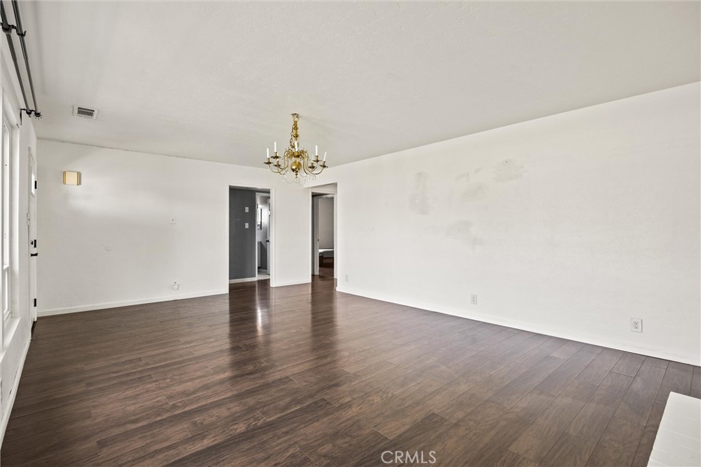 417 Jefferson Street Willows, CA 95988 - Photo 6 of 32 a view of an empty room with wooden floor and a window