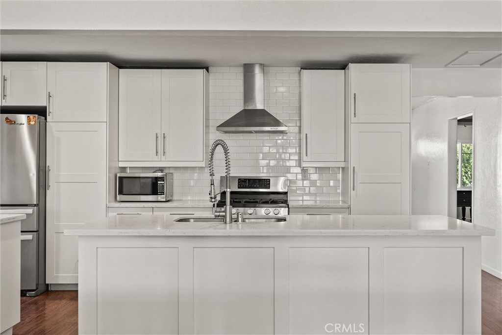 417 Jefferson Street Willows, CA 95988 - Photo 7 of 32 a kitchen with stainless steel appliances a stove a refrigerator and cabinets