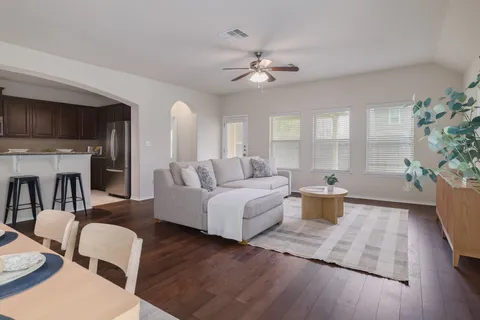 a living room with furniture a fireplace and a flat screen tv