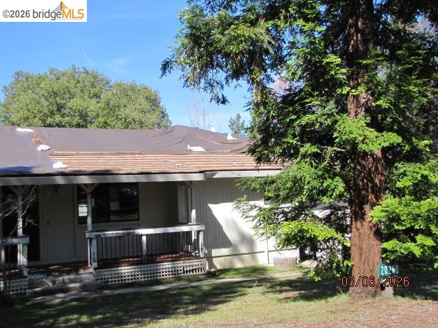 20280 Little Valley Road Groveland, CA 95321 - Photo 15 of 24 View of front of house featuring covered porch and a front yard