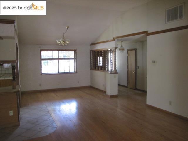 20280 Little Valley Road Groveland, CA 95321 - Photo 10 of 32 an empty room with wooden floor and windows