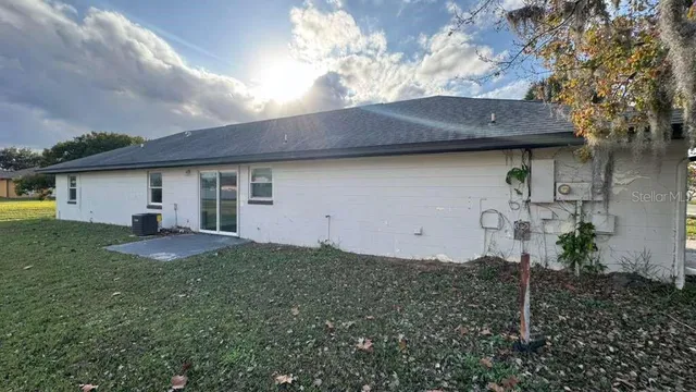 a backyard of a house with table and chairs