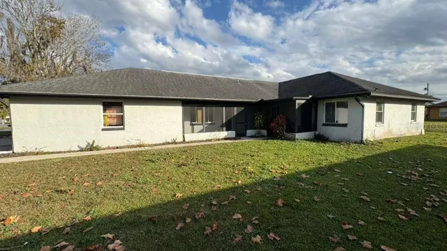 a front view of house with yard and trees